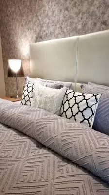 a bed with pillows on it in a bedroom at Luxury Paramount Hotel Apt B327 in Dubai