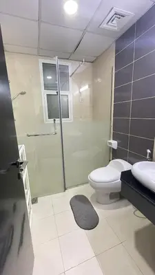 a bathroom with a shower and a toilet and a sink at Holiday Rental in Dubai