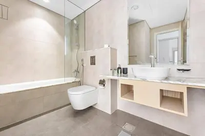 a bathroom with a sink and a toilet and a tub at StoneTree - Paramount 3BR - Panoramic View in Dubai