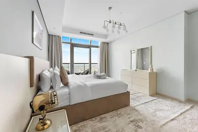 a bedroom with a large bed and a large window at StoneTree - Paramount 3BR - Panoramic View in Dubai