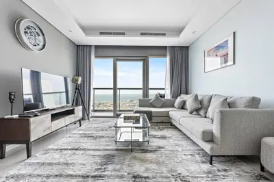 a living room with a couch and a table at StoneTree - Paramount 3BR - Panoramic View in Dubai