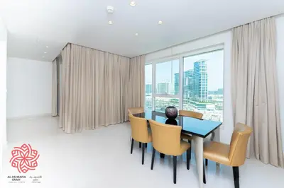 a dining room with a table and chairs and a window at Alashrafia Saray- Waterfront 3 BDR apartment Business Bay in Dubai