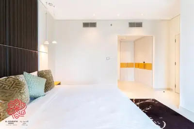 a bedroom with a large bed and a hallway at Alashrafia Saray- Waterfront 3 BDR apartment Business Bay in Dubai