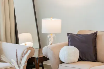 a living room with a chair and a lamp at Dubai Marina,JBR -Luxurious 2 BR King Suite in Dubai