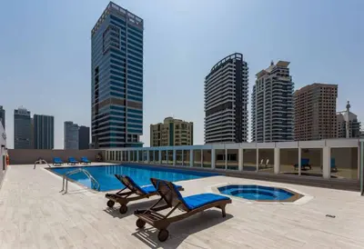 a swimming pool on top of a building with buildings at Dubai Marina,JBR -Luxurious 2 BR King Suite in Dubai