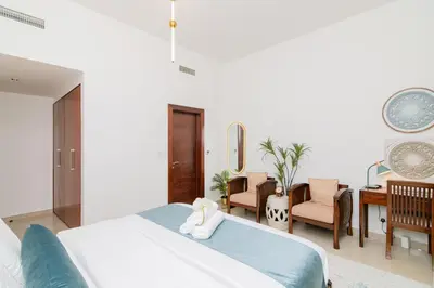 a bedroom with a bed with a stuffed animal on it at Dubai Marina,JBR -Luxurious 2 BR King Suite in Dubai
