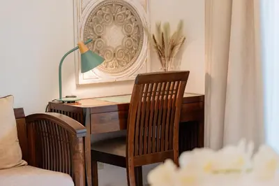 a desk with a lamp and a table and chairs at Dubai Marina,JBR -Luxurious 2 BR King Suite in Dubai