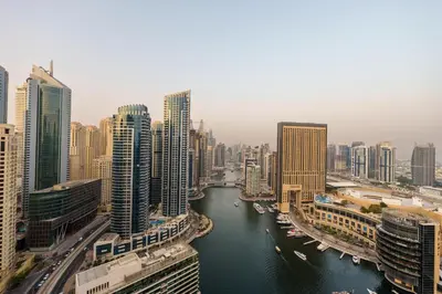 a river in a city with tall buildings at Maison Privee - Dreamy Apt with Jaw-Dropping Marina Views in Dubai