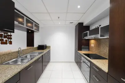a kitchen with a sink and a counter top at Maison Privee - Dreamy Apt with Jaw-Dropping Marina Views in Dubai