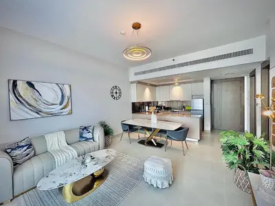 a living room with a couch and a table at Modern 1 BR Apartment at JVC Dubai Prime Location! in Dubai