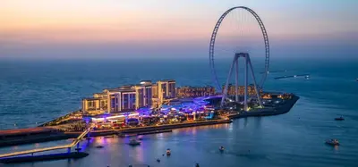 a view of a city with a ferris wheel at night at Bluewaters Residences - Sea View, Bluewaters Island - Mint Stay in Dubai