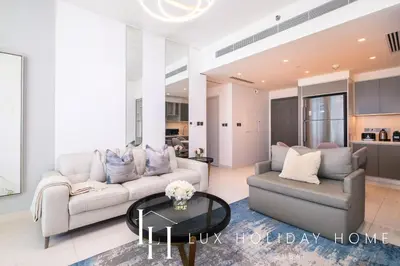 a living room with a couch and a table at LUX The Luxury Sunrise Beachfront Suite 2 in Dubai