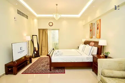a bedroom with a bed and a couch at Luxury Escapes - Modern Studio Apt - Steps to Metro, Marina Mall and JBR Beach - Marina Pearl in Dubai