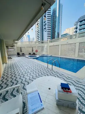 a swimming pool on the roof of a building at Luxury Escapes - Modern Studio Apt - Steps to Metro, Marina Mall and JBR Beach - Marina Pearl in Dubai