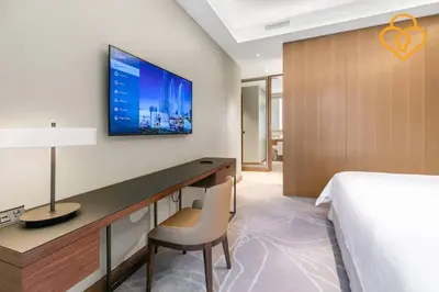 a bedroom with a bed and a desk and a tv at Keysplease 2BR Apt Address Opera Minutes to Dubai Mall, Downtown 29 in Dubai