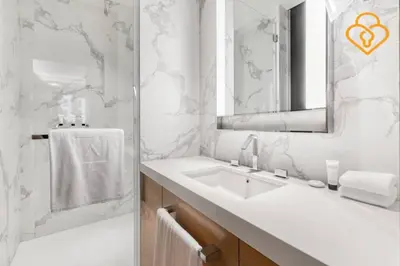 a white bathroom with a sink and a mirror at Keysplease 2BR Apt Address Opera Minutes to Dubai Mall, Downtown 29 in Dubai