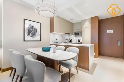 a kitchen and dining room with a white table and chairs at Keysplease 2BR Apt Address Opera Minutes to Dubai Mall, Downtown 29 in Dubai