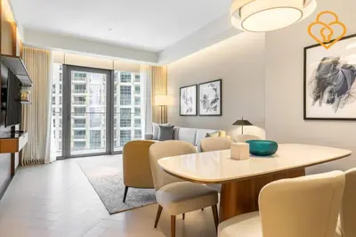 a dining room and living room with a table and chairs at Keysplease 2BR Apt Address Opera Minutes to Dubai Mall, Downtown 29 in Dubai