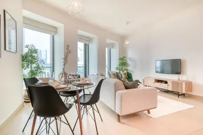 a living room with a couch and a table and chairs at Burj Vista Tower 1 - City View, Downtown Dubai - Mint Stay in Dubai