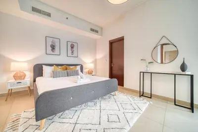 a bedroom with a large bed and a mirror at Burj Vista Tower 1 - City View, Downtown Dubai - Mint Stay in Dubai