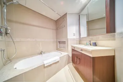 a bathroom with a tub and a sink and a mirror at Burj Vista Tower 1 - City View, Downtown Dubai - Mint Stay in Dubai