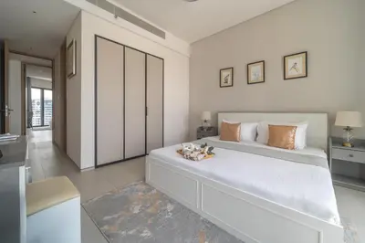 a bedroom with a large white bed with two stuffed animals on it at Frank Porter - The Address JBR in Dubai