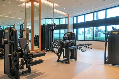 a gym with a bunch of treadmills and ellipticals at Frank Porter - The Address JBR in Dubai