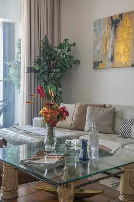 a living room with a glass table and a couch at Frank Porter - The Address JBR in Dubai