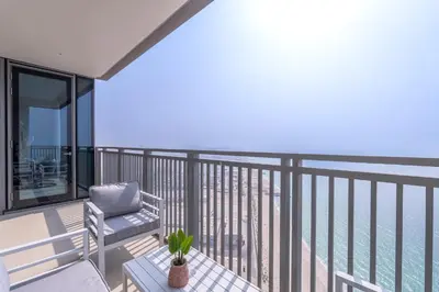 a balcony with a chair and a table at Sunset spot with breathtaking view by Suiteable in Dubai