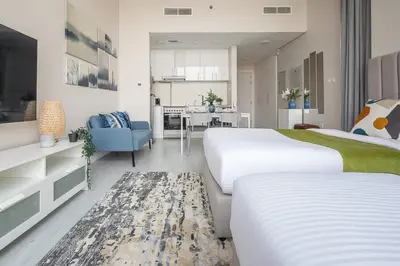 a hotel room with two beds and a kitchen at Frank Porter - Square Tower in Dubai