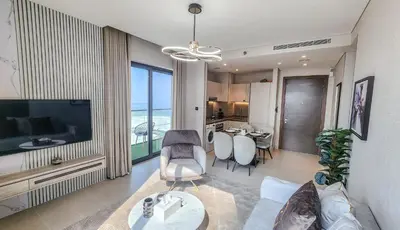 a living room with a couch and a table with chairs at STAY BY LATINEM Luxury 2BR Holiday Home CV A2301 near Burj Khalifa in Dubai