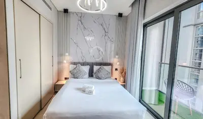 a bedroom with a large bed and a large window at STAY BY LATINEM Luxury 2BR Holiday Home CV A2301 near Burj Khalifa in Dubai