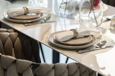 a table with plates and utensils on a table at Magnificent 3BR Spectacular Canal & Burj View in Dubai