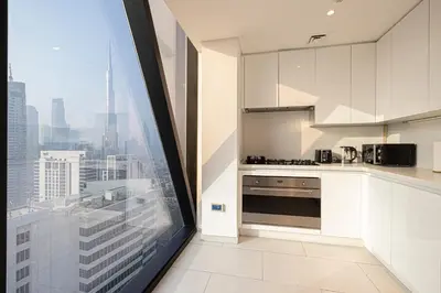 a kitchen with a view of a city skyline at Magnificent 3BR Spectacular Canal & Burj View in Dubai