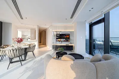 a living room with a table and a dining room at Magnificent 3BR Spectacular Canal & Burj View in Dubai