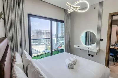 a bedroom with a bed and a large window at STAY BY LATINEM Luxury 1BR Holiday Home W1006 near Burj Khalifa in Dubai