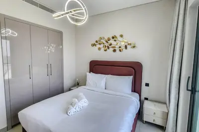 a bedroom with a large white bed with white pillows at STAY BY LATINEM Luxury 1BR Holiday Home W1006 near Burj Khalifa in Dubai