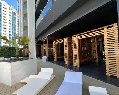 a group of white benches on a building at Chez Fouzia in Dubai
