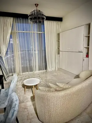 a living room with a couch and a table at Chez Fouzia in Dubai