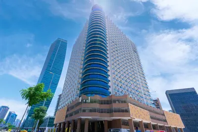 a tall building with many windows in a city at Elegant Studio in City Center with Balcony in Dubai