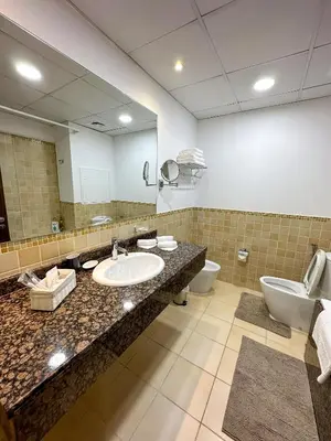 a bathroom with a sink and a toilet and a mirror at Shams Apart on JBR - 1 Bedroom - Marina View in Dubai