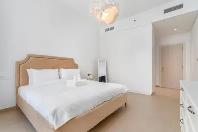 a white bedroom with a large bed in a room at 1bdr in Belgravia Heights - JVC - Dubai in Dubai
