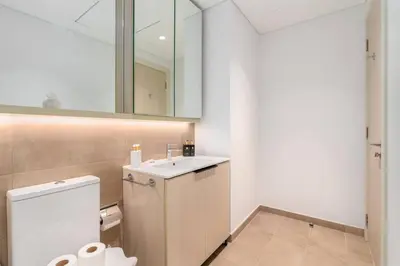 a bathroom with a toilet and a sink and a mirror at 1bdr in Belgravia Heights - JVC - Dubai in Dubai