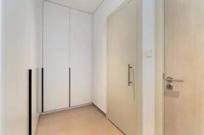 an empty room with a door and a corridor at 1bdr in Belgravia Heights - JVC - Dubai in Dubai