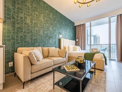 a living room with a couch and a table at Superb Studio in Luma 21-JVC in Dubai