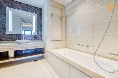 a bathroom with a shower and a tub and a sink at Keysplease Luxury 1 B/R Apt in Paramount Towers by Damac in Dubai