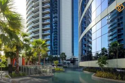 a view of a building with palm trees and a swimming pool at Keysplease Luxury 1 B/R Apt in Paramount Towers by Damac in Dubai
