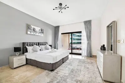 a bedroom with a large bed and a window at StoneTree - Fairmont North 2 BR - Beach Access in Dubai