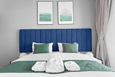 a bedroom with a blue and white bed with two pillows at StoneTree - Attessa Tower 1BR - Amazing View in Dubai