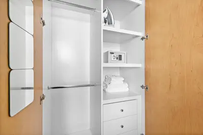 a white closet with a door and a mirror at StoneTree - Attessa Tower 1BR - Amazing View in Dubai